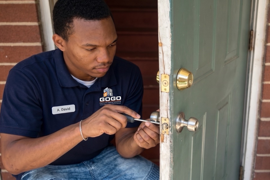 GOGO Facility Maintenance technician repairing a door lock and handle